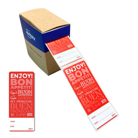 Kuvassa on laatikko, jossa on punainen etiketti, jossa lukee 'ENJOY! BON APPETIT!' useilla kielillä, sekä kentät tilausta ja nimeä varten. Laatikko on Averyltä.