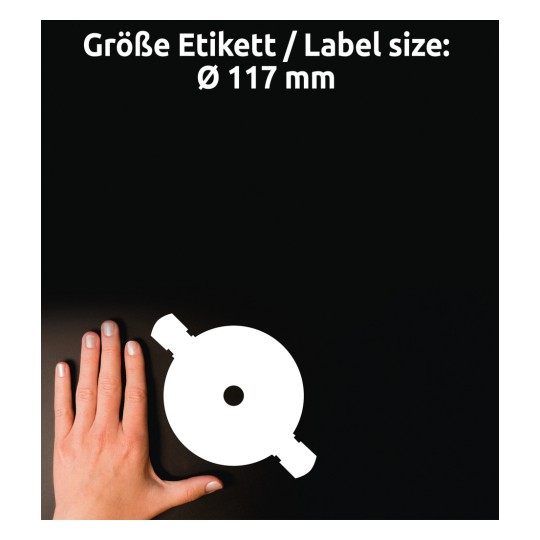 Kuvassa on käsi pyöreän etikettileikkauksen vieressä, ja tekstissä ilmoitetaan etiketin koko Ø 117 mm saksaksi ja englanniksi.