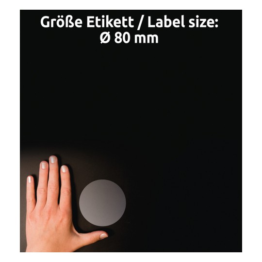 Kuvassa on käsi, joka on sijoitettu lähelle pyöreää etikettiä tummalla taustalla, ja etiketin koko on ilmoitettu valkoisella tekstillä Ø 80 mm.